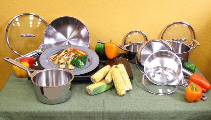 True Induction DBSET package cookware arranged on a table; the cooktop is not shown